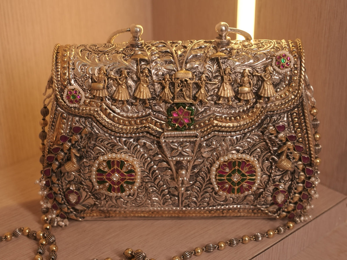 Front of the sterling silver purse, with a gold-tone wedding procession across the flap and meena work medallions below.