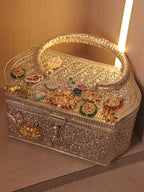 Top view of the charm studded lid, with elephants, an evil eye disc, enamelled hearts and stone set flowers.