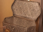 The box purse open on its hinge, showing the finished engraved interior of the lid and body.