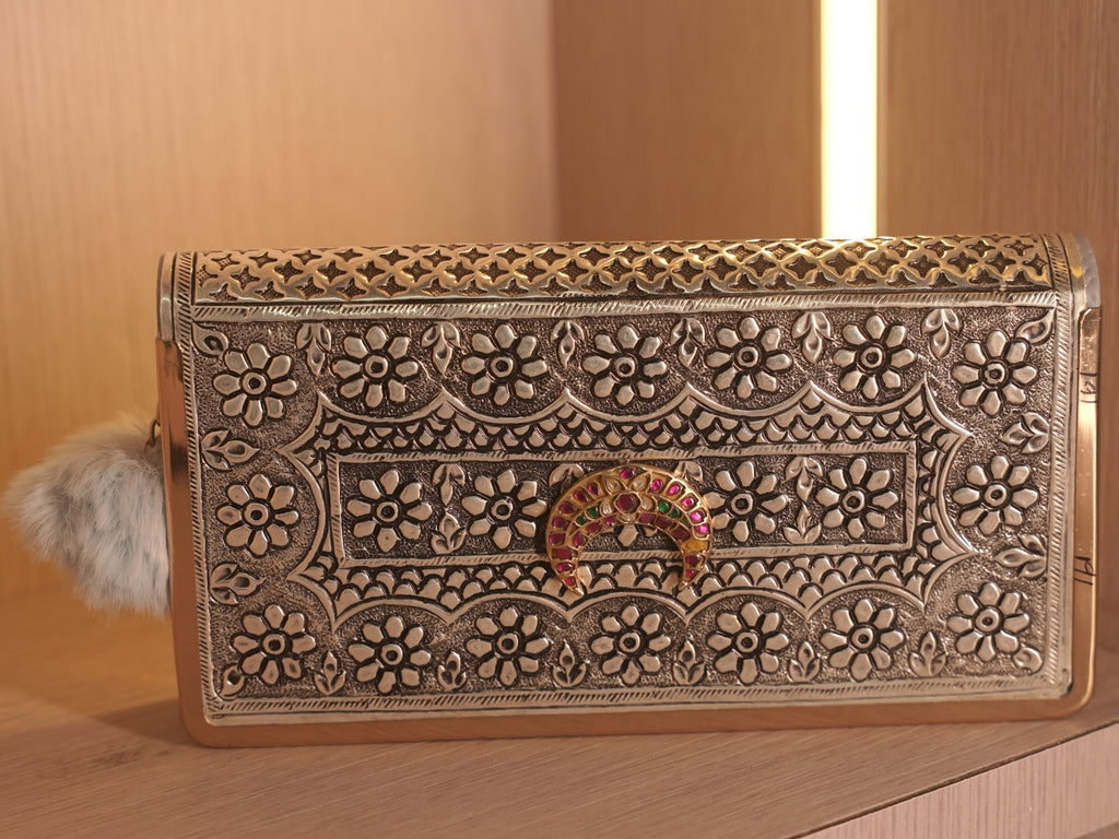 Straight on view of the clutch wallet face, with the gold accent running along the border of the flap.