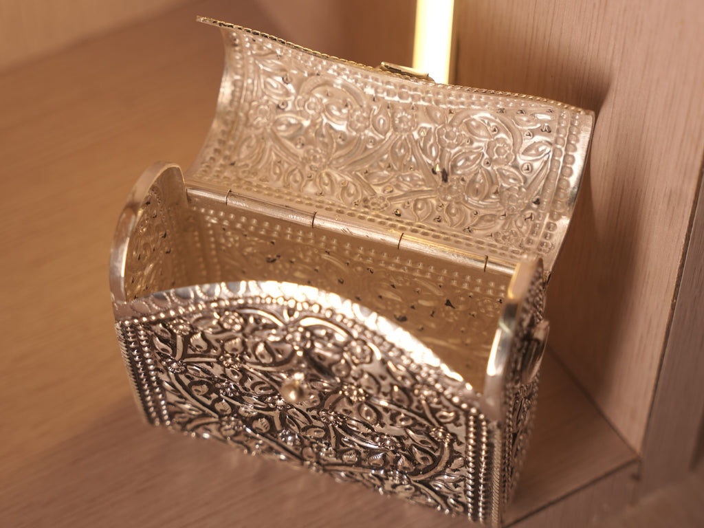 Top down view of the open oxidised box bag, showing the hinged lid and engraved inner faces.
