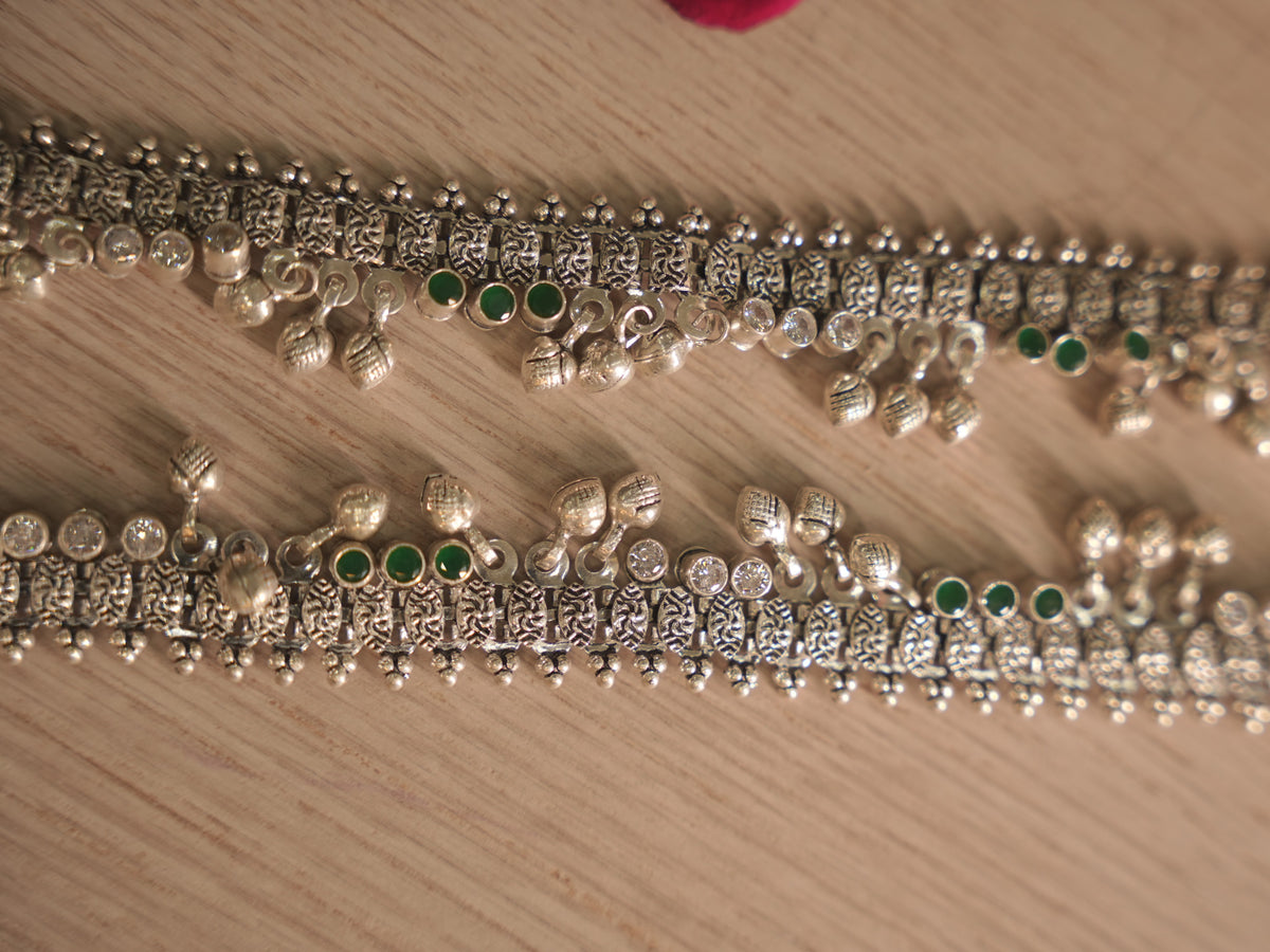 Section of the oxidised silver payal with leaf drops and ghungroos hanging from the lower edge.