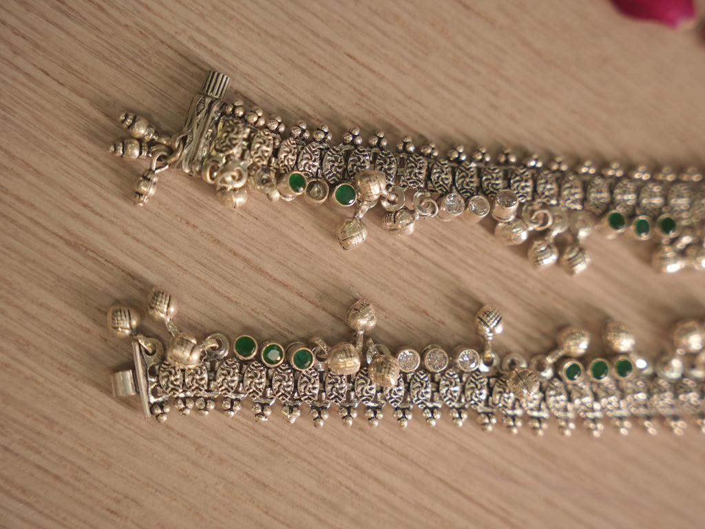 Clasp end of the oxidised silver payal, showing the pillar shaped end piece and tab closure.