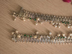 Clasp end of the oxidised silver payal, showing the pillar shaped end piece and tab closure.