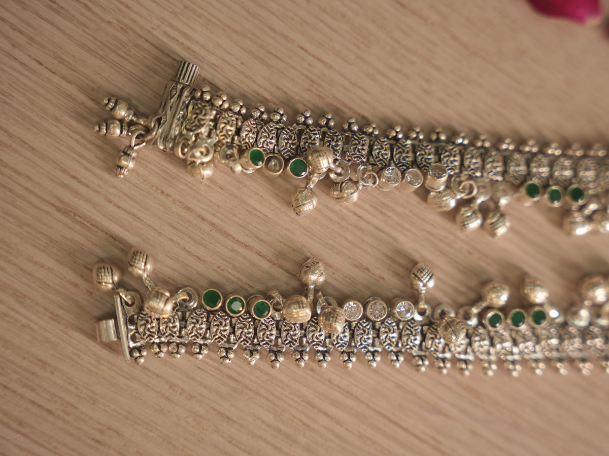 Clasp end of the oxidised silver payal, showing the pillar shaped end piece and tab closure.