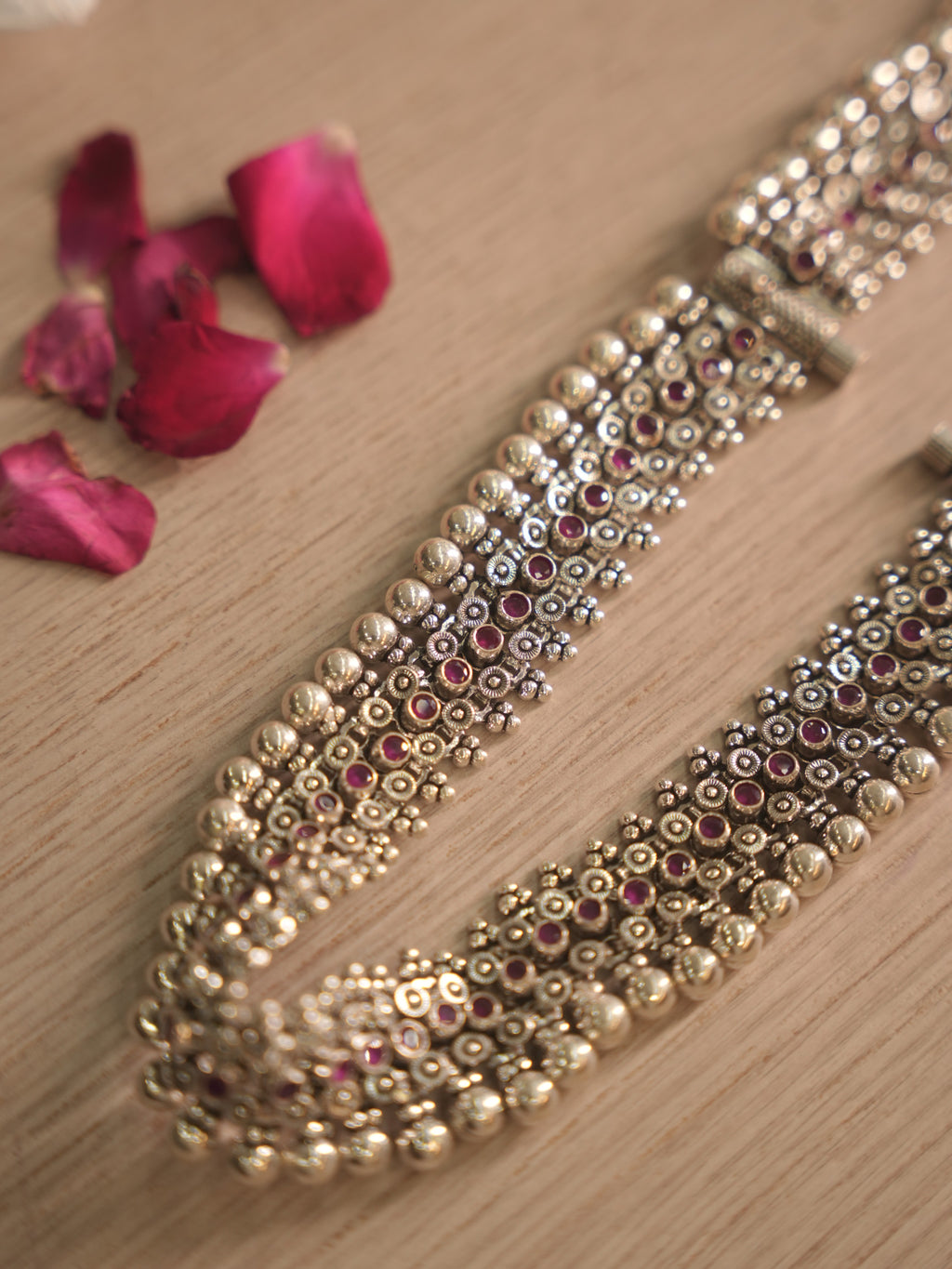 Both silver payal standing on edge, showing the dome bead borders and the depth of the lattice work.