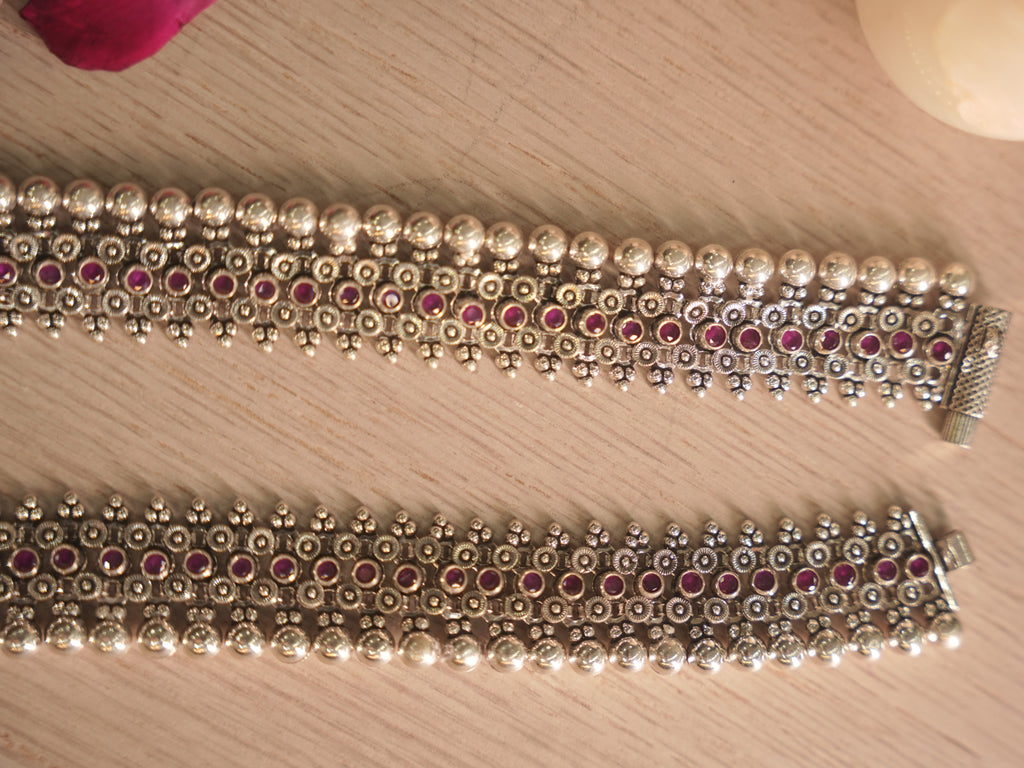 Detail of the silver payal edge, showing polished dome beads beside the floral jaali.