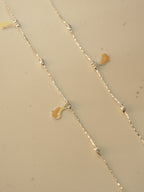 Close view of the enamel butterflies and silver beads on the pair of payal.