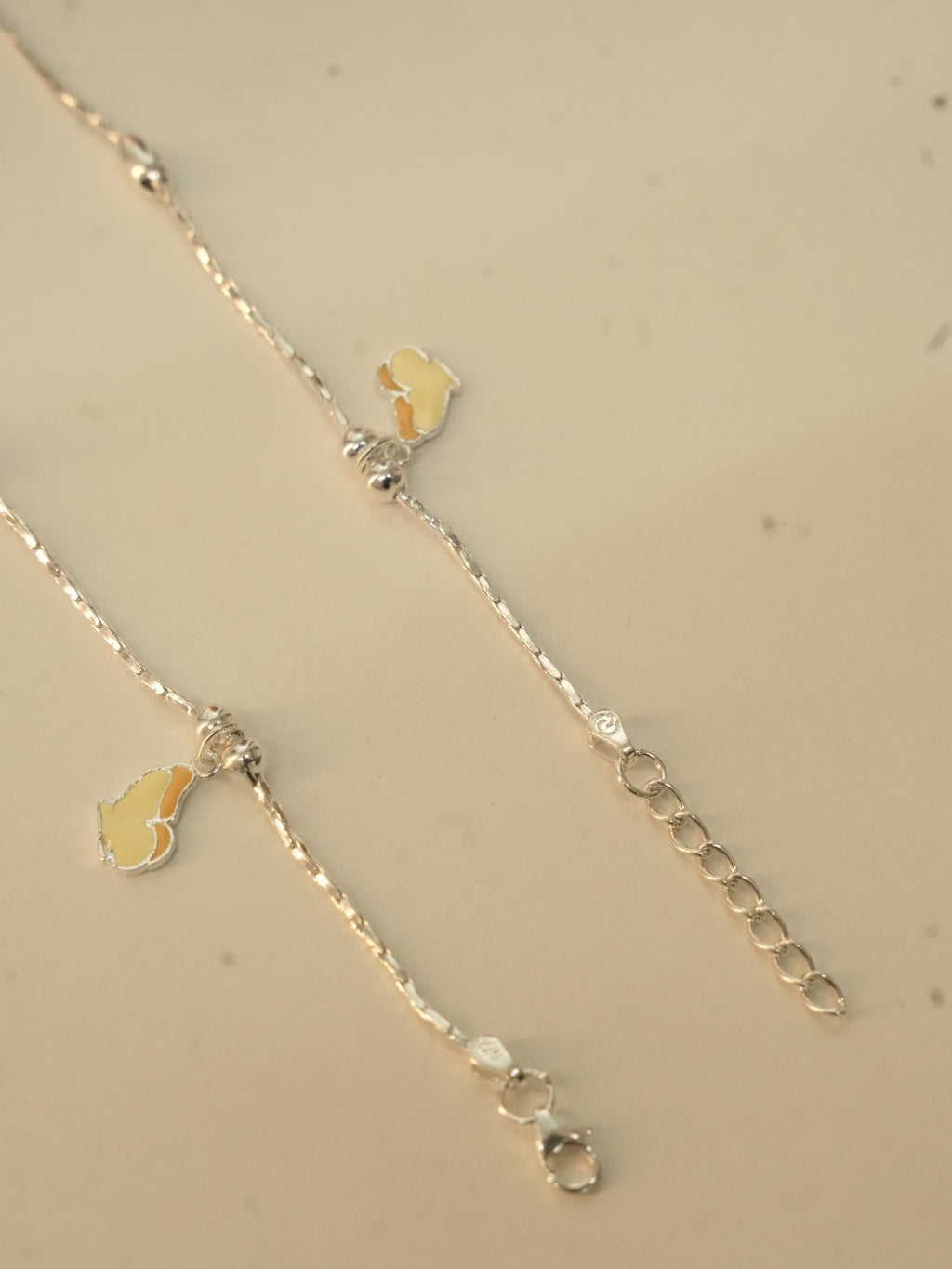 Clasp end of the butterfly payal, showing the lobster clasp and the extender chain.