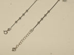 Spring ring clasp and extender chain with a heart tag on the cube charm payal.