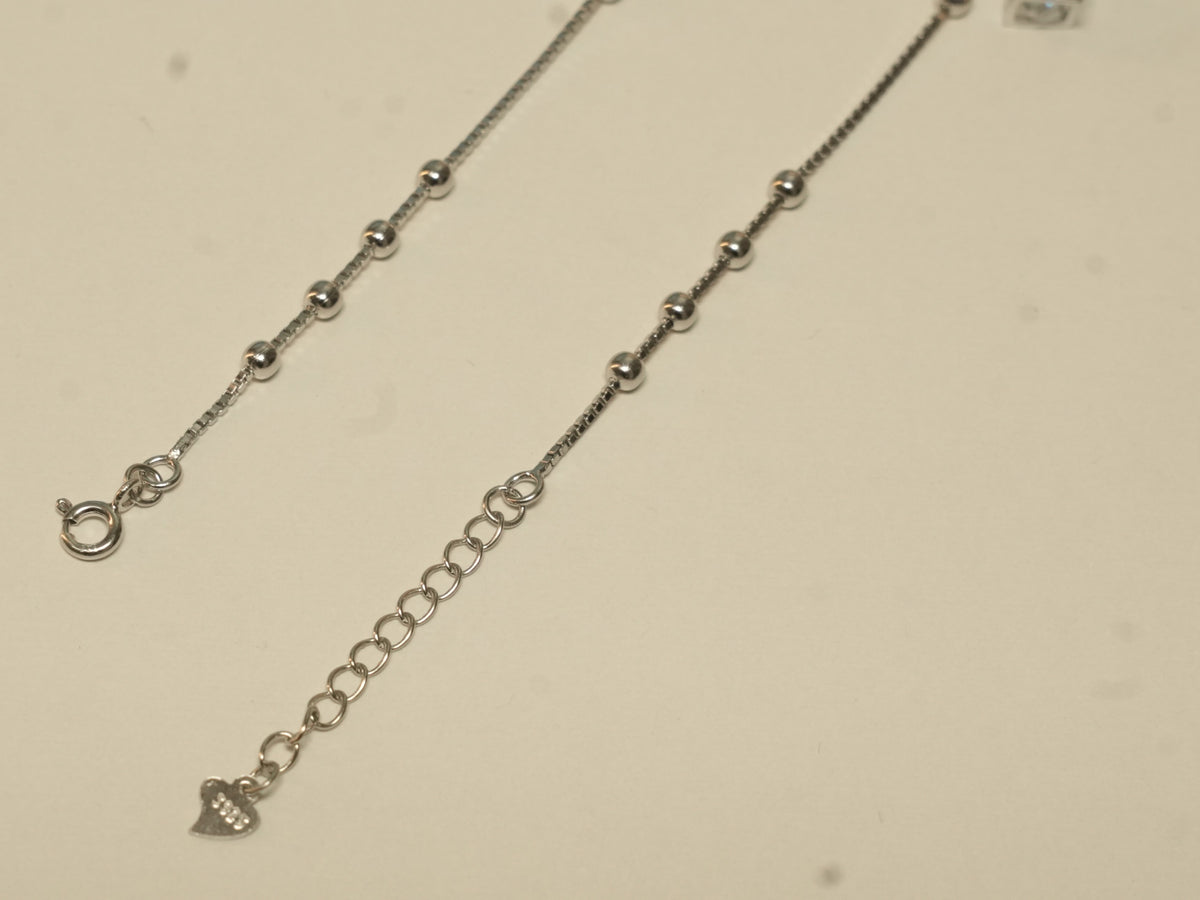 Spring ring clasp and extender chain with a heart tag on the cube charm payal.