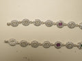 Pair of sterling silver payal made of oval halo links, with a deep pink stone link on each.