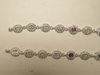 Pair of sterling silver payal made of oval halo links, with a deep pink stone link on each.