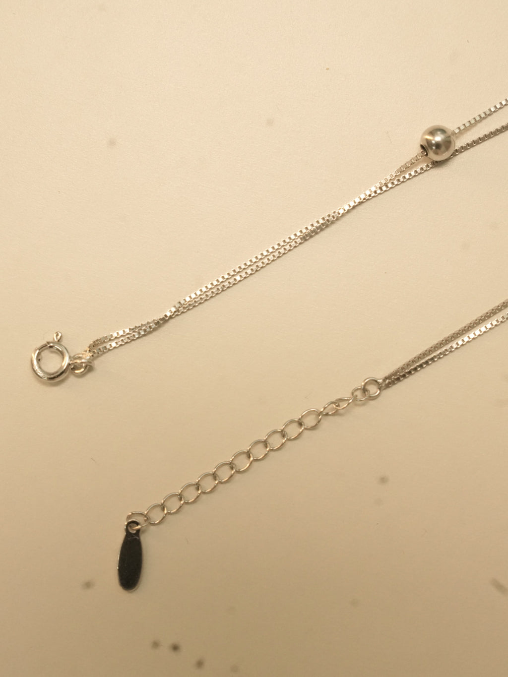 Spring ring clasp and extender chain with an oval tag on the five heart payal.