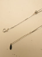 Spring ring clasp and extender chain with an oval tag on the five heart payal.