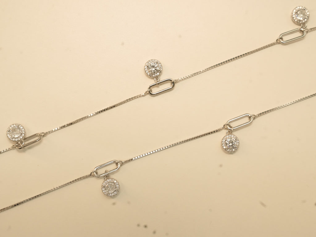 Pair of silver payal with paperclip links, each link carrying a round American Diamond halo drop.