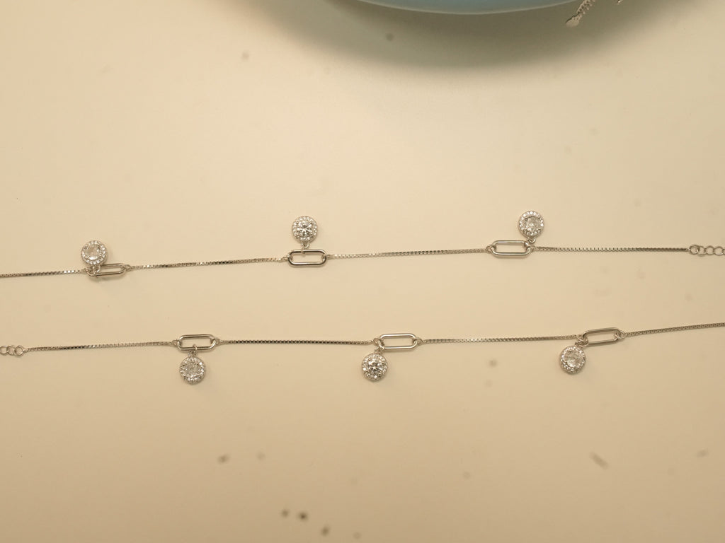 The pair of silver payal laid out full length, showing the paperclip links and the extender chain.