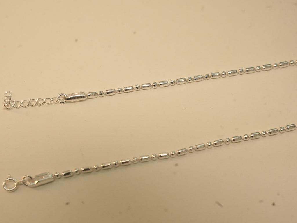 Spring ring clasp and extender chain on the bar and bead payal.