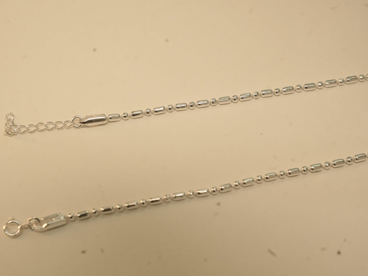 Spring ring clasp and extender chain on the bar and bead payal.