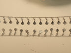 Pair of silver payal with a fringe of flower pierced discs, each hanging from a bezel set American Diamond.