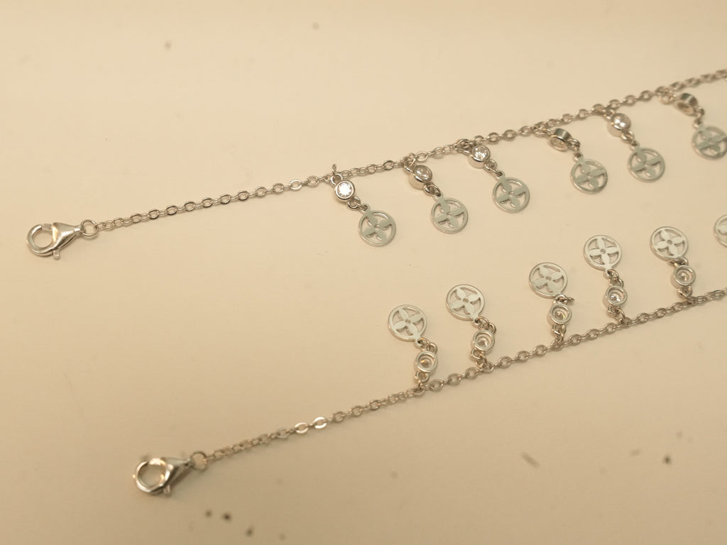 Lobster clasp ends of the flower disc payal, with the first discs of the fringe.
