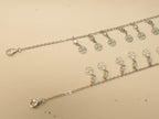 Lobster clasp ends of the flower disc payal, with the first discs of the fringe.