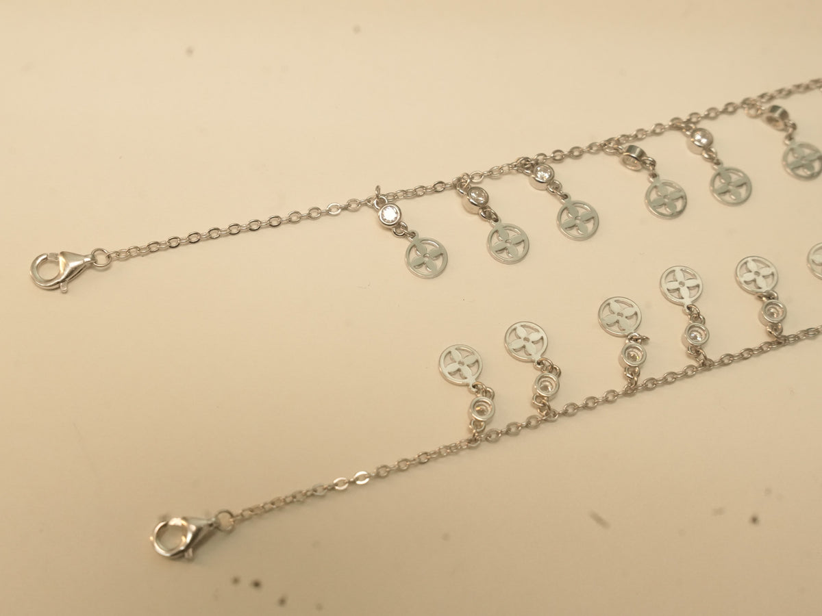 Lobster clasp ends of the flower disc payal, with the first discs of the fringe.