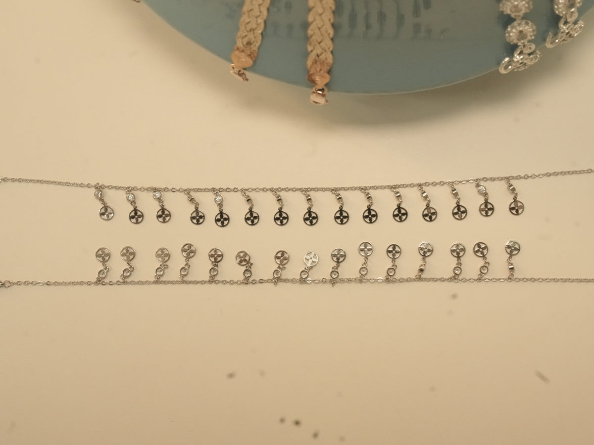 The pair of flower disc payal laid out to show the full fringe.