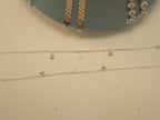 The pair of heart and star payal laid out to show the three charms on each.