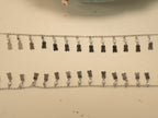 Pair of silver payal with a fringe of mirror polished tags, each hanging from a bezel set American Diamond.