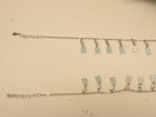 Extender chain ends of the mirror tag payal, with the first tags of the fringe.