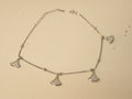 Sterling silver anklet with four fan shaped American Diamond charms, laid in a loop.