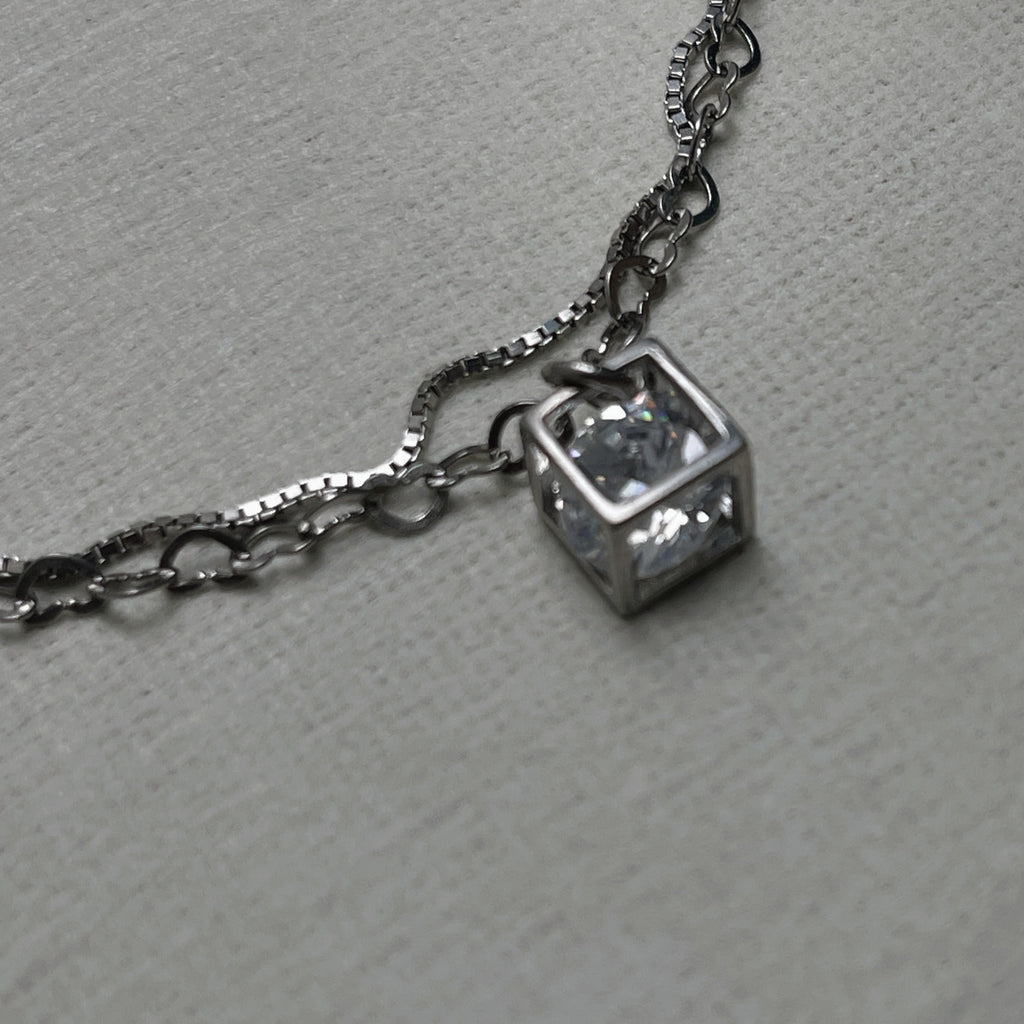 Close-up of the open silver cube with the American Diamond held inside it.