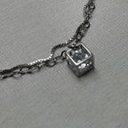 Close-up of the open silver cube with the American Diamond held inside it.