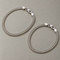A pair of sterling silver popcorn chain payal laid side by side.