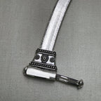 The pin of the clasp drawn out, showing how the bar slides through the barrel.