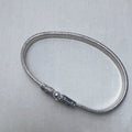 Pair of rajwadi silver payal: one anklet laid in a full loop with the pin clasp closed.