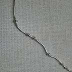 Close-up of the snake chain and the evenly spaced silver beads of the payal pair.