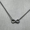 Sterling silver anklet with a love knot half set with American Diamonds, on a double curb chain.
