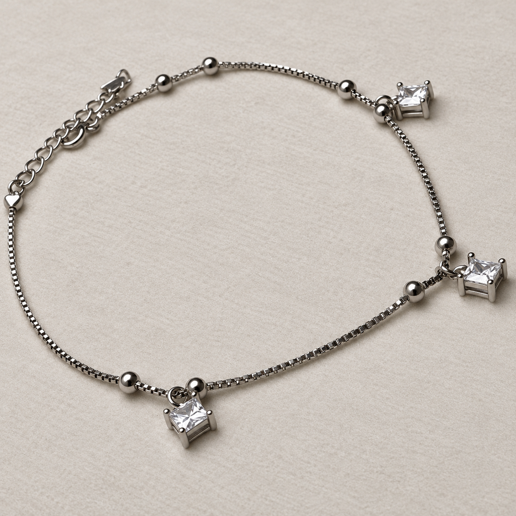 The anklet laid out to show the three square American Diamond drops and the extender chain.