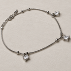 The anklet laid out to show the three square American Diamond drops and the extender chain.