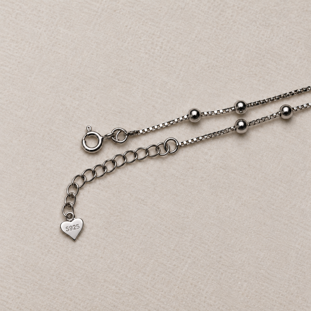 The spring ring clasp, extender chain and heart tag of the American Diamond drop anklet.