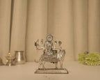 Back of the silver Durga idol, showing the disc behind her head and the patterned cloth over the tiger.