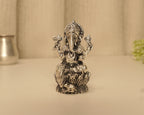 The antique silver Ganesh idol seen straight on from the front.