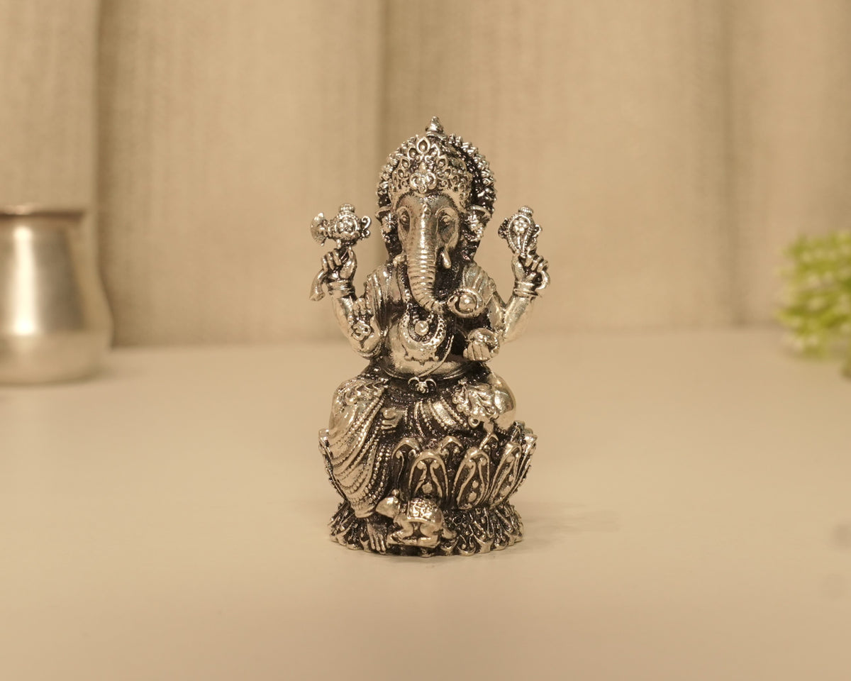 The antique silver Ganesh idol seen straight on from the front.