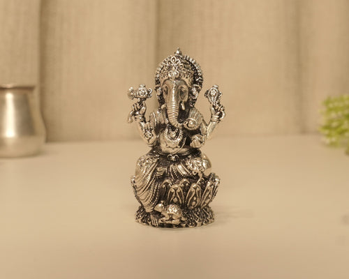 The antique silver Ganesh idol seen straight on from the front.
