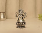 The back of the antique silver Ganesh idol at full height, showing the disc above the lotus base.