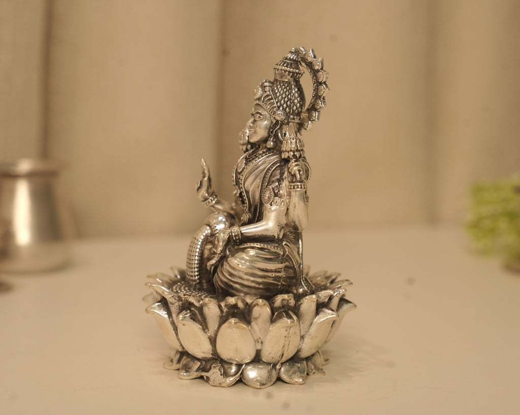 Side view of the large silver Lakshmi idol, showing the depth of the lotus base.