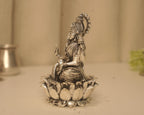 Side view of the large silver Lakshmi idol, showing the depth of the lotus base.
