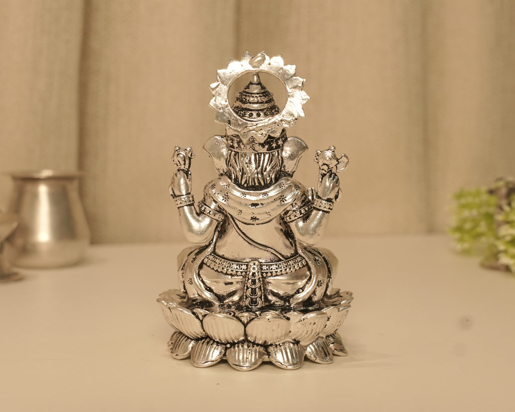 Back of the large silver Ganesh idol, showing the crown within the beaded arch.